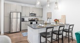 a kitchen with light colored cabinets