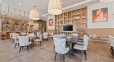 clubhouse with massive bookshelves and wall mounted tv