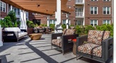 pergola covered patio with chairs and tables
