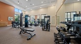 open fitness center with ample lighting throughout