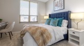 spacious bedroom with a study area