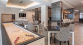 game area with shuffleboard table in clubhouse