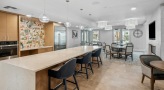 clubhouse kitchen with chairs at a long island