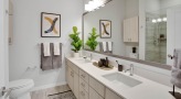 a bathroom with a large mirror and double sink vanity counter