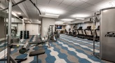 carpeted fitness center with ample lighting