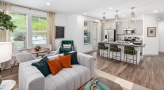 a living room with a large window and dining area