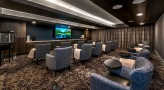 a room with a large screen and chairs