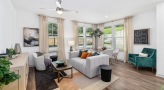 spacious living room surrounded by large windows