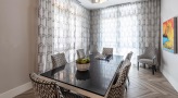a dining room table with chairs and a chandelier