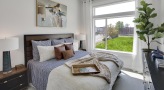 a bedroom with a large window