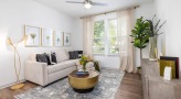 well lit living room with a couch and a table