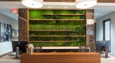Resident lounge and lobby at Overture Yorktown 55 and older apartments in Lombard, IL, featuring a front desk.