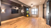 exercise room with wood flooring and window