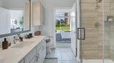 well lit bathroom with a walk-in shower