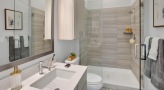 a bathroom with a glassed, walk-in shower