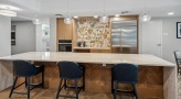 clubhouse kitchen with a bar and chairs