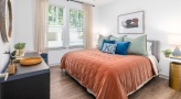 large windows brighten bedroom