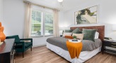 a bedroom with ceiling fan and light fixture