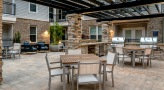 pergola covered patio with tables and chairs