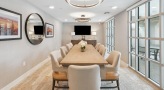 bright conference room with a large table surrounded by chairs