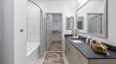 shower/tub combo in bright bathroom with walk-in closet