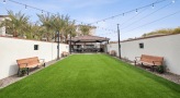 a large green lawn with benches