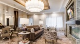 Resident lounge at Overture Stone Oak apartments in San Antonio, TX, featuring couches, and modern lighting fixtures.