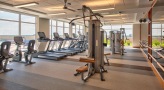Large fitness center with large windows and plenty of equipment