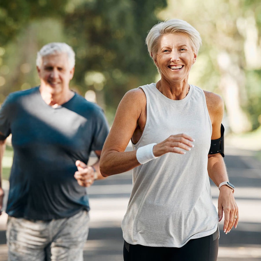 7 Dimensions to Wellness man and woman on a run in a park