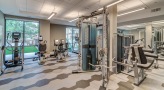 Large fitness center with large windows and plenty of equipment