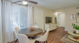 living area with a dining table and chairs