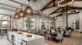 Large well lit lounge with bar seating and large windows
