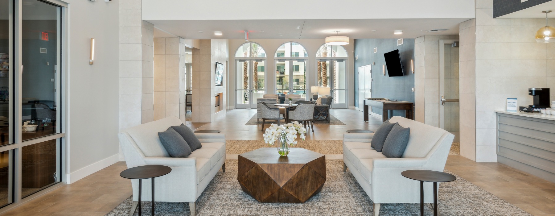 Resident lounge and lobby at Overture North Scottsdale senior community in Arizona, featuring couches and a coffee table. 