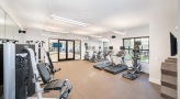 Large fitness center with large windows and plenty of equipment