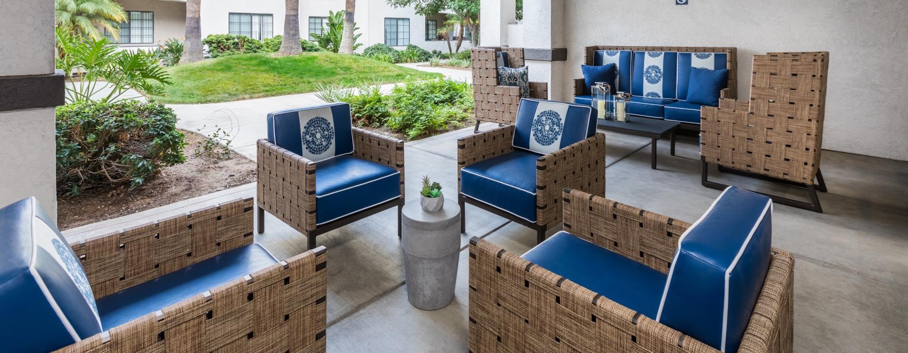 Outdoor lounge at Overture San Marcos over 55 apartments in San Marcos, CA, featuring cushioned seating.