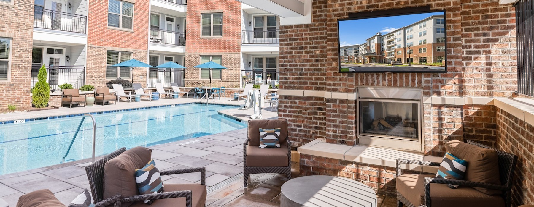 The outdoor lounge at Overture Cary senior living apartments in Cary, NC, featuring a flat screen TV.