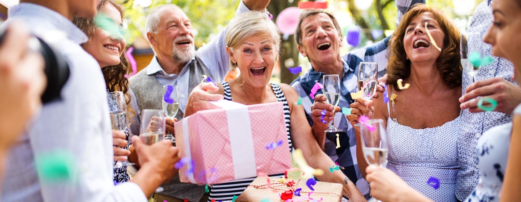 A birthday party at Overture Centennial senior living apartments in Raleigh, NC, featuring residents celebrating.