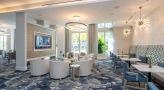 large well lit lounge with ample seating 