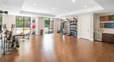 Well lit yoga studio with wood floors 