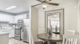 kitchen with a table, chairs and white cabinets