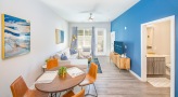 Well lit dining area with wood floors 