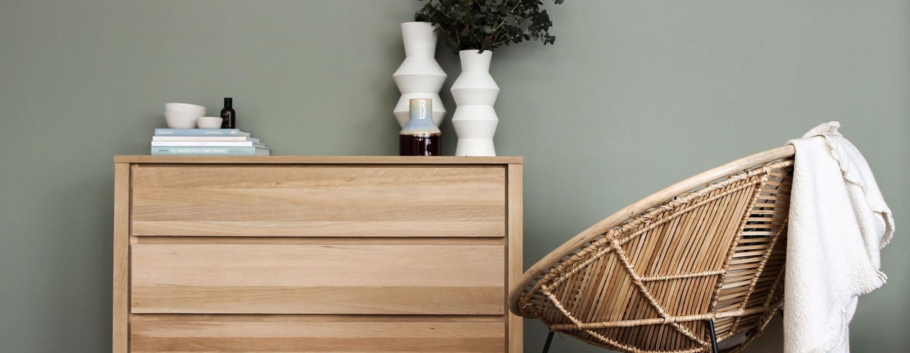 Detail of a model bedroom at Overture West Ashley senior living apartments in Charleston, SC, featuring wooden furniture.
