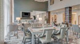 large well lit game room with seating a billiards