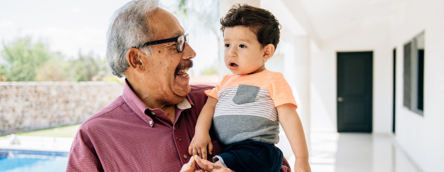 A resident and child at Overture Rancho Santa Margarita over 55 apartments in Orange County, CA, featuring natural light.