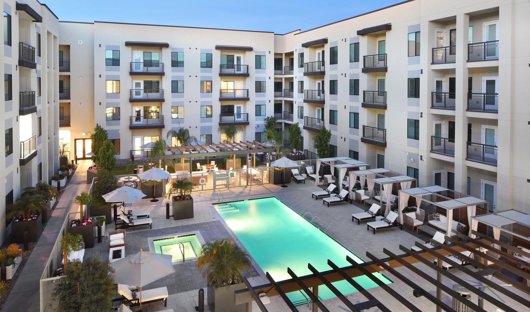 Aerial view of the outdoor lounge at Overture Fair Ridge senior living apartments in Fairfax, VA, featuring a pool.