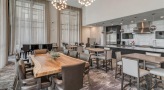 large lounge with wood tables and bar seating