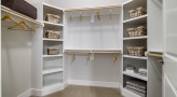 Walk-in closet with built-in wooden shelving