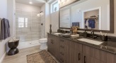 large bathroom with brown accents and closet space
