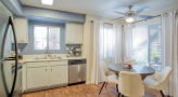 kitchen with a table, chairs and white cabinets