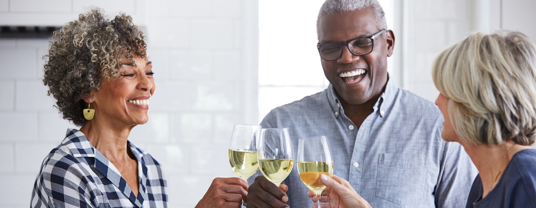 Residents holding up wine glasses at Overture Daniel Island senior living apartments in Charleston, SC.